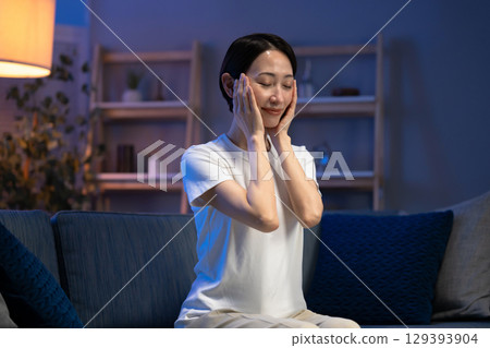 Middle-aged woman doing skin care before going to bed Middle-aged woman doing skin care before going to bed 129393904