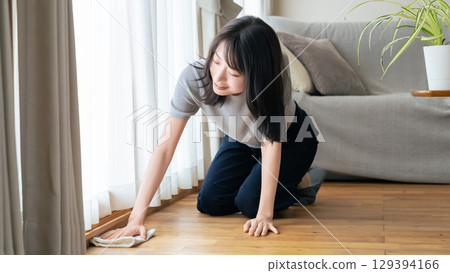 A woman mopping the floor A woman mopping the floor 129394166