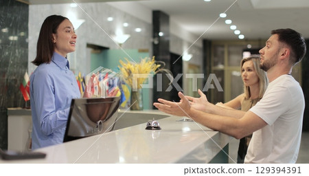 Man frustrated for argument, mistake in hotel lobby. Conflict, customer and manager with dispute, angry booking crisis and upset with service. Man frustrated for argument, mistake in hotel lobby. Conflict, customer and manager with dispute, angry booking crisis and upset with service. 129394391