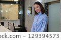 Portrait of professional woman manager of hotel at reception looking at camera. Concierge service, woman smile in lobby for check in assistance, reservation and help. 129394573
