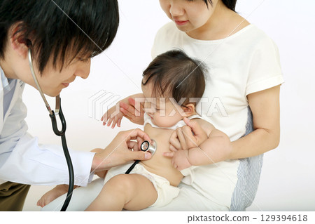 A baby being examined with a stethoscope while being held by his mother A baby being examined with a stethoscope while being held by his mother 129394618