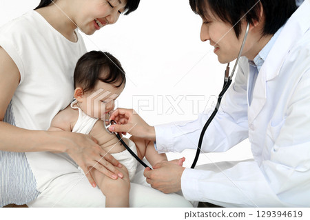 A baby being examined with a stethoscope while being held by his mother A baby being examined with a stethoscope while being held by his mother 129394619