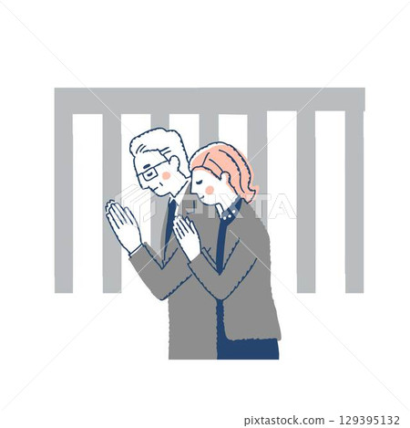 身著喪服的男女一起祈禱 身著喪服的男女一起祈禱 129395132