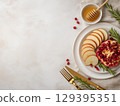 Flat lay of symbolic Rosh Hashanah foods: apples, honey, and pomegranate 129395351
