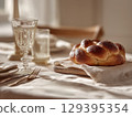 Elegant Shabbat table setting with round challah 129395354