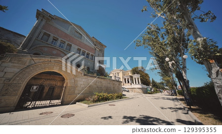 Abandoned mansion decaying in Crimea under blue summer sky 129395355