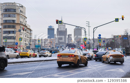 Taxis driving on Smolenskaya street in Moscow with Ministry of Foreign Affairs building in background 129395386