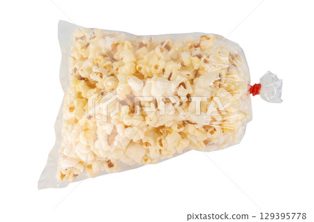 Popcorn in a Plastic Bag Tied with a Rubber Band on White Background 129395778