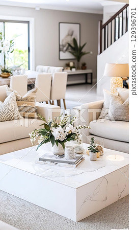 White coffee table with a vase of flowers on it 129396701