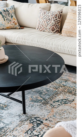 Black coffee table sits in front of a white couch 129396815