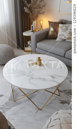 White marble coffee table with a gold frame sits in a living room 129396829