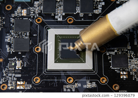 The image shows the application of thermal silicone to the CPU chip. 129396879