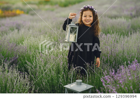 Provence child relaxing in lavender field. Little lady in a black dress. Girl with bag. Provence child relaxing in lavender field. Little lady in a black dress. Girl with bag. 129396994