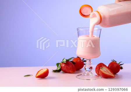 Strawberry milkshake smoothie and fresh berries on a colorful background. Strawberry milkshake smoothie and fresh berries on a colorful background. 129397066