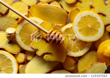 Honey with fresh ginger and lemon slices. Honey with fresh ginger and lemon slices. 129397083