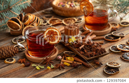 Christmas herbal tea with ingredients on a old wooden table. 129397084