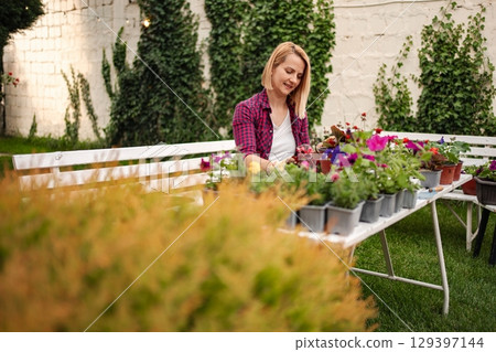 Gardening joy in a sunlit backyard retreat Gardening joy in a sunlit backyard retreat 129397144