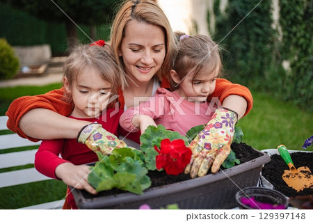 Gardening fun with children in a vibrant backyard setting Gardening fun with children in a vibrant backyard setting 129397148