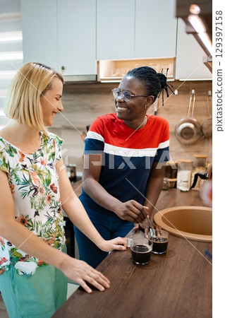 Enjoying coffee and conversation in a cozy kitchen setting 129397158