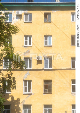 Air conditioners are installed on facade of building. device for comfortable living in hot weather. 129397350