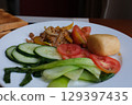 Vegan salad fruits and vegetables dish with avocado, dragon fruit, radish, pumpkin, tomato, corn salad, lettuce, mizuna and lemon on white background. Healthy food 129397435