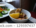 Soup chicken potatoes Spicy bbq chicken legs with grilled oranges, onions, garlic and potatoes close-up on a plate on a table. horizontal top view from above 129397437