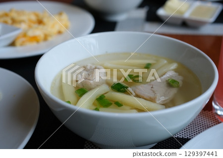 chicken broth with meatballs Bowl of instant noodles isolated on white background. chicken broth with meatballs Bowl of instant noodles isolated on white background. 129397441