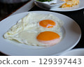 two heart shaped eggs on a plate Asian food, sunny side up fried egg on rice for breakfast image 129397443