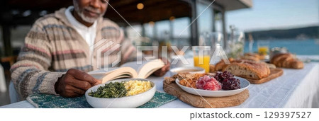 Solo traveler enjoying a peaceful breakfast outdoors, surrounded by fresh food and a beautiful view, embracing freedom and self-discovery 129397527
