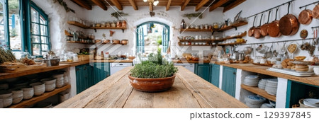 This cottage kitchen showcases rustic charm, featuring natural wood furnishings and fresh herbs on the table 129397845