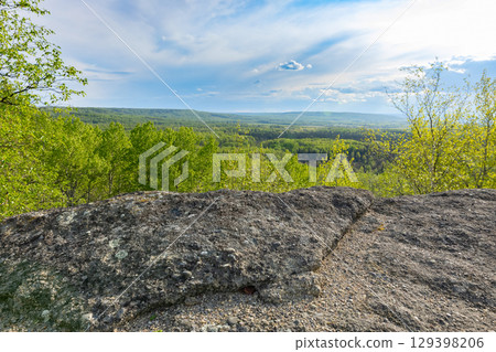 Valley view from the top of rock formation in the forested area. Valley view from the top of rock formation in the forested area. 129398206