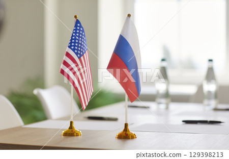 Flags of USA and Russia on meeting table symbolizing diplomatic negotiations between partners. 129398213