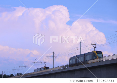 Utsunomiya City: LRT crossing the Kinugawa River and thunderclouds Utsunomiya City: LRT crossing the Kinugawa River and thunderclouds 129398233