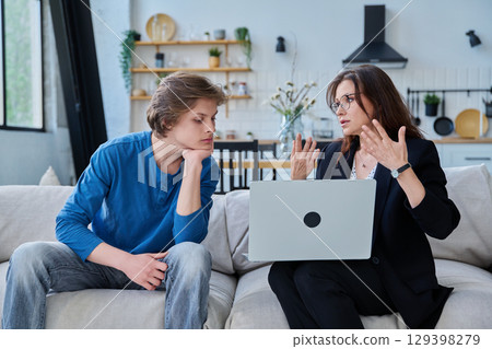 Female social worker working at home with teenage guy 129398279