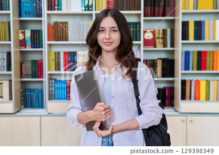 Portrait of teenage female student inside library classroom 129398349