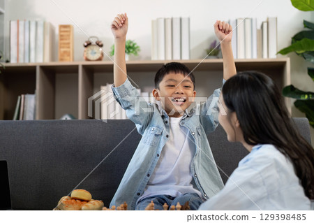 Joyful Child Celebrating Success After Chess Game 129398485