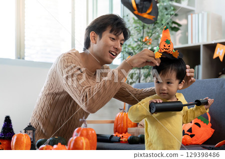 Halloween Crafting: Father Helping Son with Festive Hat Halloween Crafting: Father Helping Son with Festive Hat 129398486