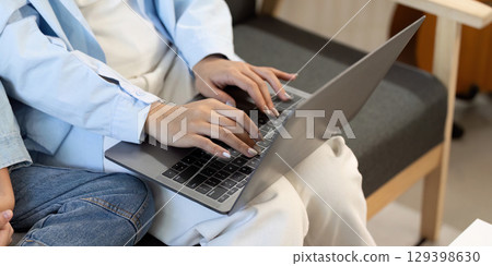 Close-up of hands typing on laptop, showcasing family engagement in learning. Close-up of hands typing on laptop, showcasing family engagement in learning. 129398630