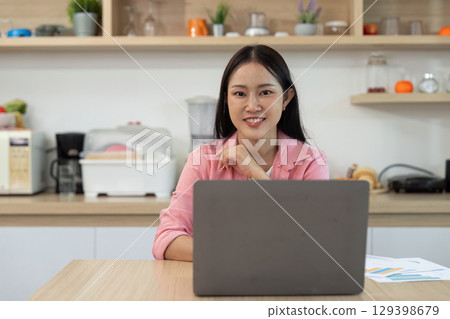 Professionalism: Confident woman smiling at camera in home office 129398679