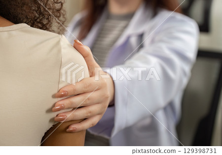 Patient Support. Doctor providing comfort during medical examination. 129398731