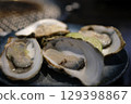 Oysters with lime on crushed ice. Edible raw seafood, view from top 129398867