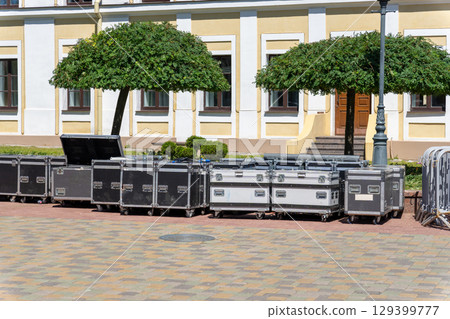 Stacked boxes filled with acoustic and lighting concert equipment 129399777