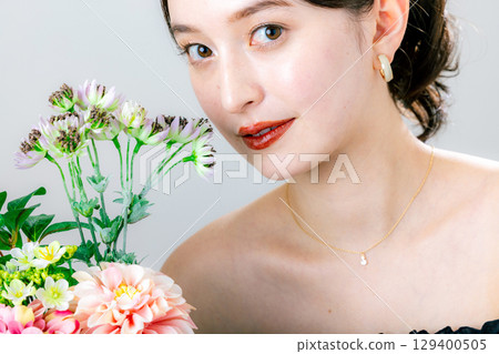 Young woman with a bouquet Young woman with a bouquet 129400505