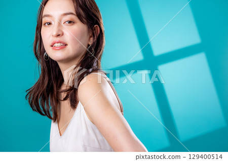 A woman standing by the window 129400514