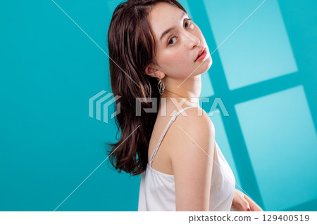 A woman standing by the window 129400519