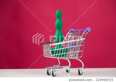 Green anal plug in miniature shopping cart.  129400725