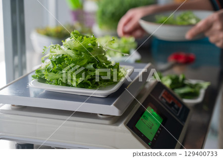 The chef lays out the salad.  129400733