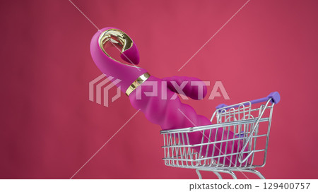 Sex toy in miniature shopping cart on pink background.  129400757