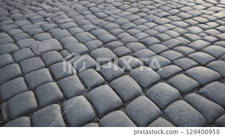 Beautifully Textured Cobblestone Pavement Illuminated by Soft Natural Light and Shadow 129400958