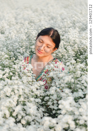 Woman (LGBTQ) posing at flower park garden field 129401712